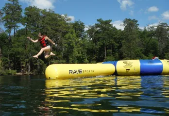 girl jumping from the water trampoline