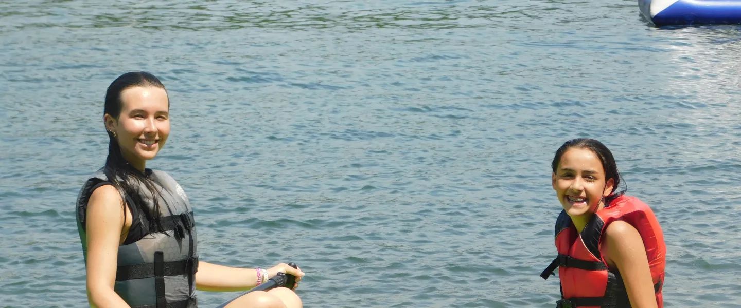 counselor and camper on SUP board